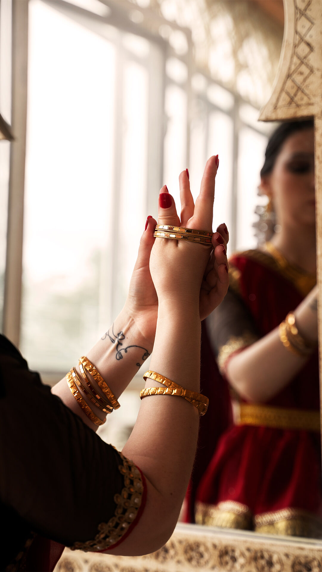 A bride wearing traditional gold bangles on her wedding